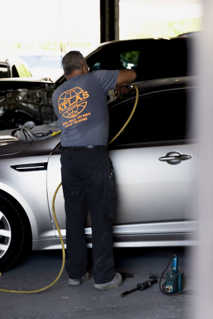 Atlas technician working on a vehicle windshield